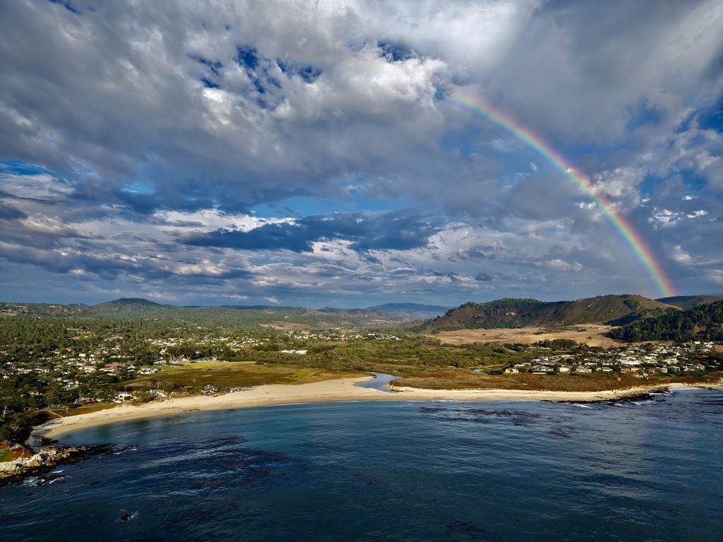 Anni McHenry photograph of Carmel State Beach with a rainbow over the coast.