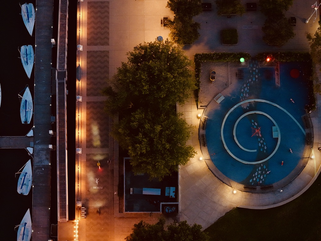 Drone photograph above Mission Rock in San Francisco, showing water, light, paths, and a circular plaza from overhead.